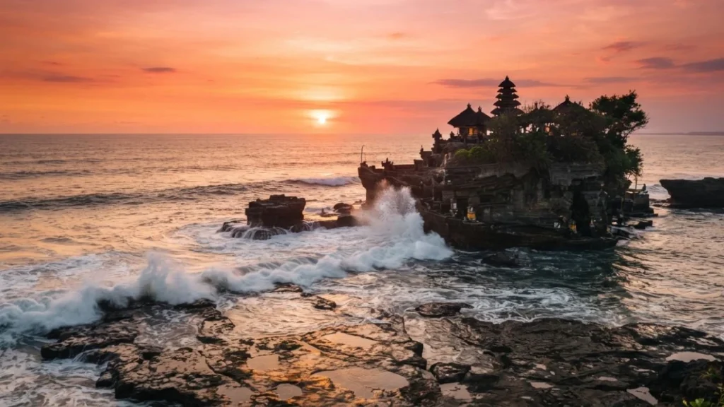 Tanah Lot Temple silhouette on ocean rock at sunset
