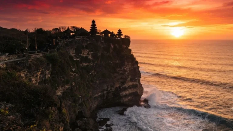 Uluwatu Temple cliff silhouette at sunset over the ocean